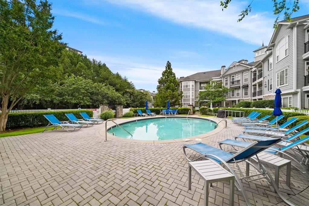 4100 Paces Walk Southeast, Unit 1101 Atlanta, GA 30339 - Photo 30 of 36 a view of a swimming pool with a lounge chair