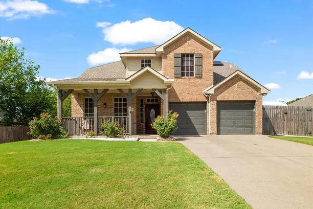 a front view of a house with a yard and porch