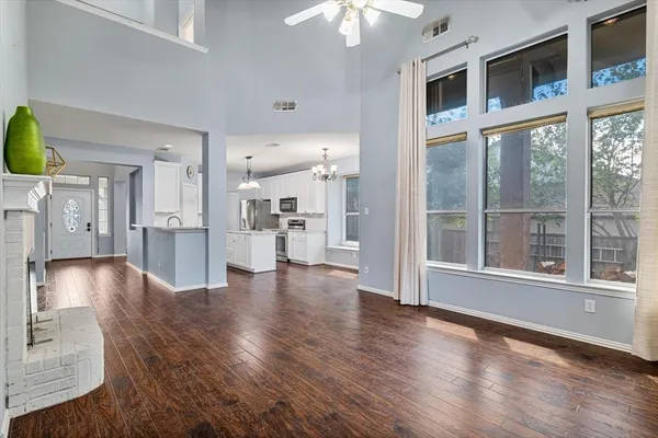 a view of a living room with hardwood floor and a large window