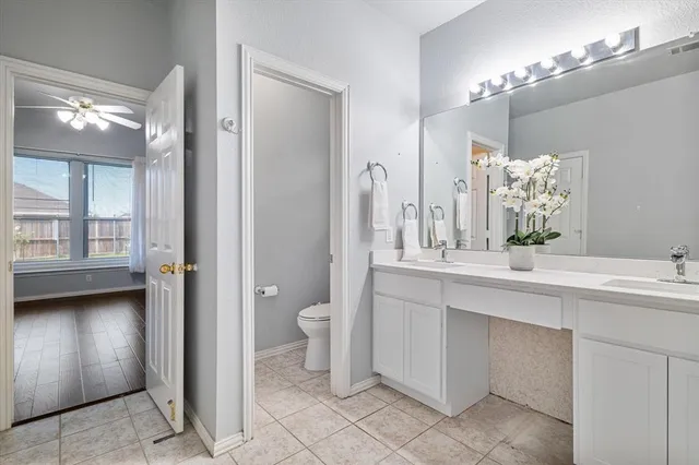 a bathroom with a sink vanity and a mirror