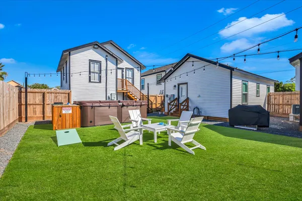 a view of a house with backyard sitting area and garden