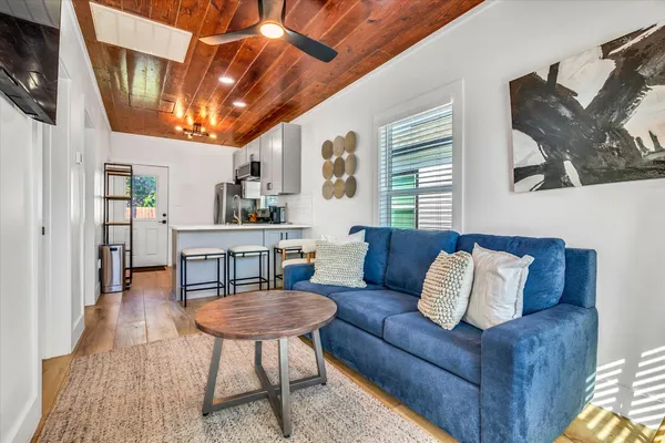 a living room with furniture a rug and a table