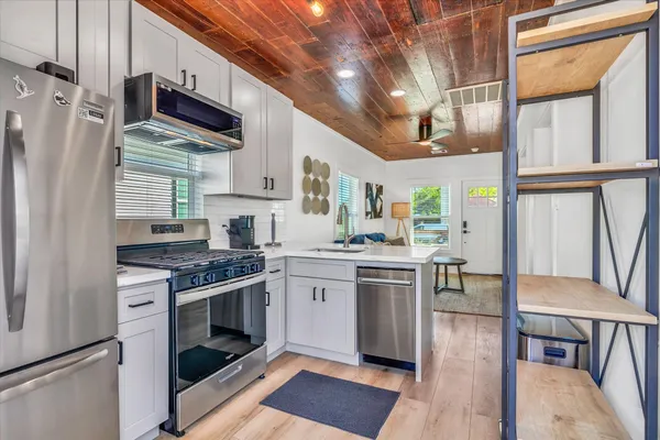 a kitchen with stainless steel appliances granite countertop a stove and a refrigerator