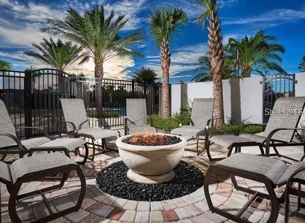 a view of a patio with chairs and plants