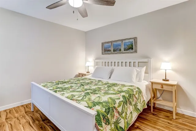 a bed sitting in a bedroom next to a lamp