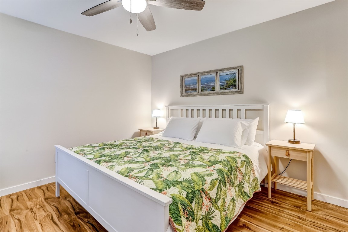 2563 Forest Ridge Drive, Unit P3 Fernandina Beach, FL 32034 - Photo 19 of 44 a bed sitting in a bedroom next to a lamp