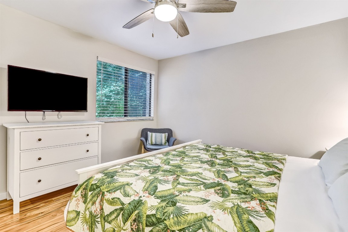 2563 Forest Ridge Drive, Unit P3 Fernandina Beach, FL 32034 - Photo 20 of 44 a bedroom with a large bed and a flat screen tv