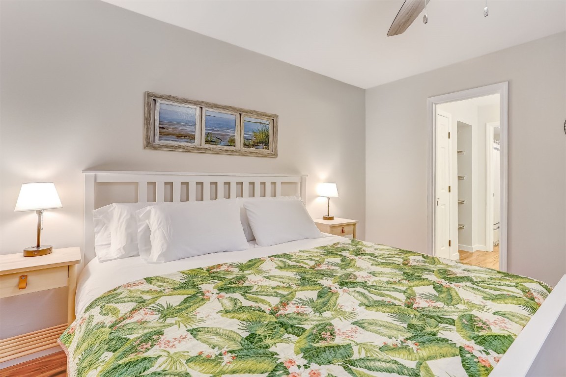 2563 Forest Ridge Drive, Unit P3 Fernandina Beach, FL 32034 - Photo 21 of 44 a bedroom with a large bed and a lamp on dresser