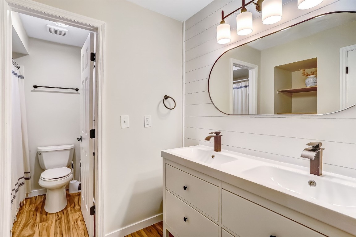 2563 Forest Ridge Drive, Unit P3 Fernandina Beach, FL 32034 - Photo 23 of 44 a bathroom with a toilet a sink and a mirror