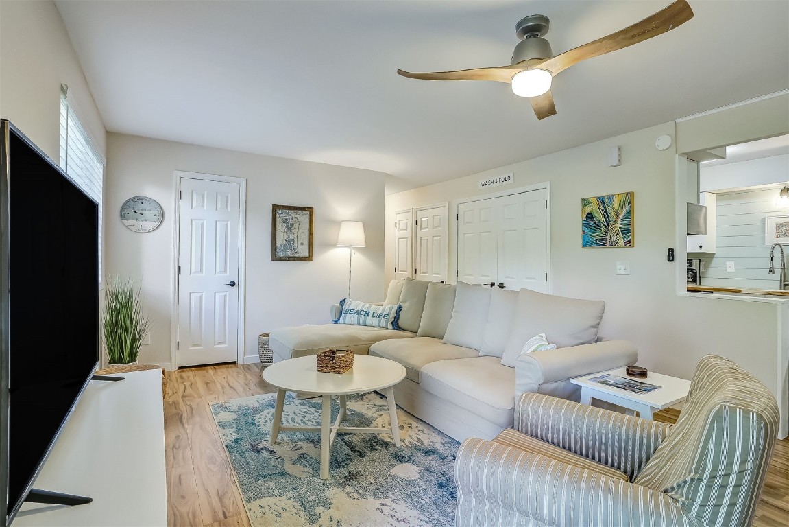 2563 Forest Ridge Drive, Unit P3 Fernandina Beach, FL 32034 - Photo 10 of 44 a living room with furniture and a chandelier