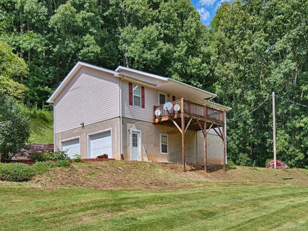 1059 Sugar Cove Road Clyde, NC 28721 - Photo 14 of 14 a front view of a house with a garden