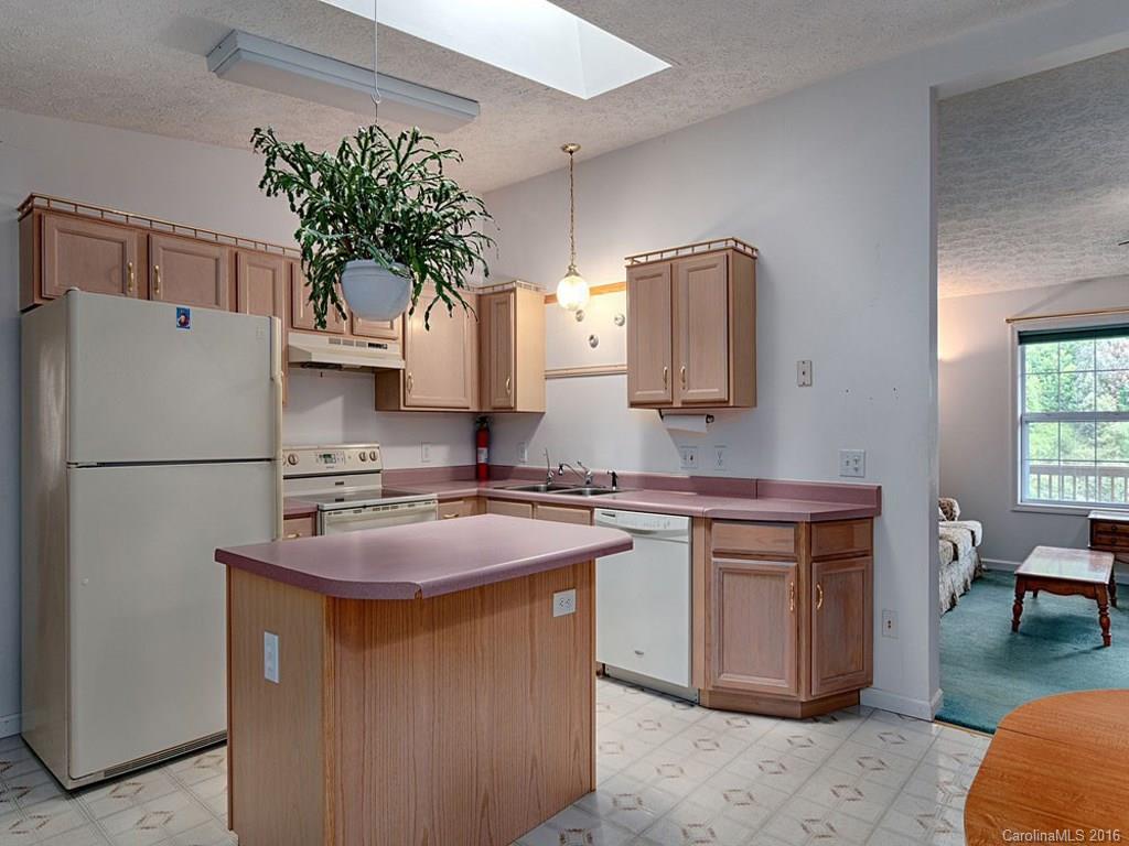 1059 Sugar Cove Road Clyde, NC 28721 - Photo 5 of 14 a kitchen with stainless steel appliances granite countertop a refrigerator a stove a sink and a refrigerator