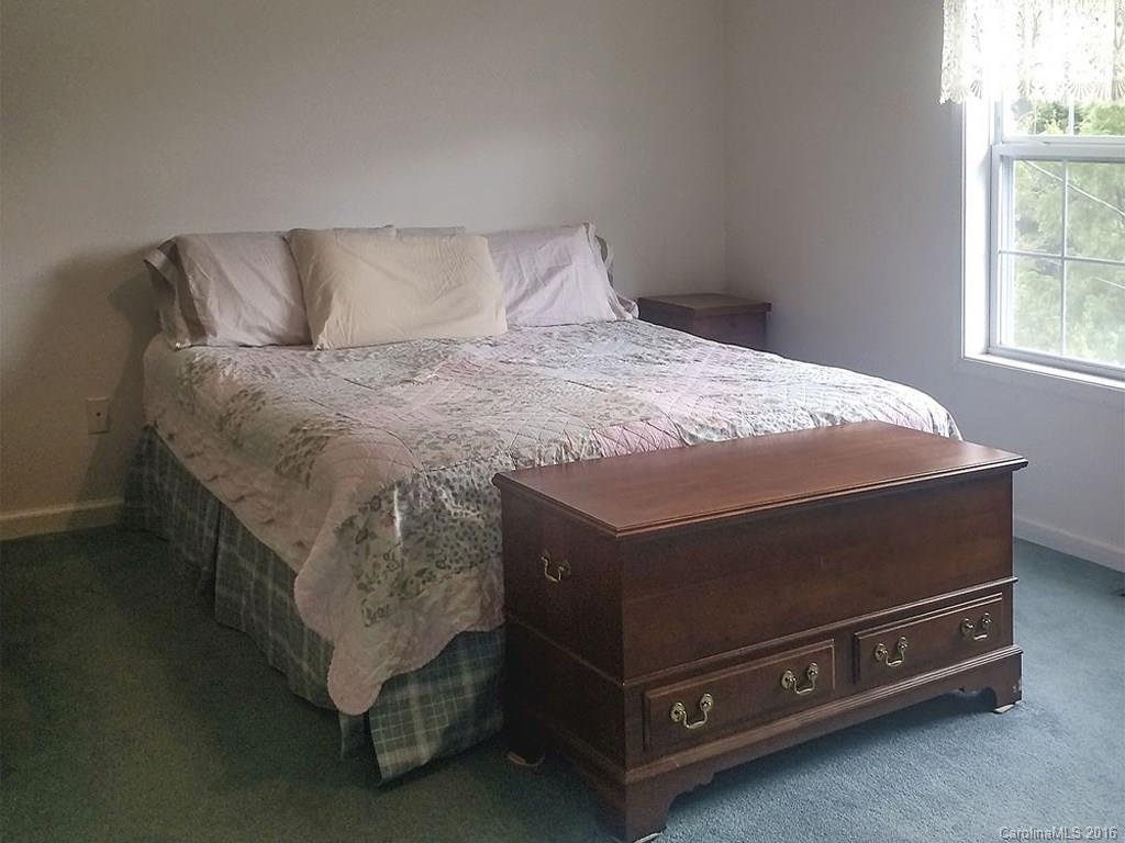 1059 Sugar Cove Road Clyde, NC 28721 - Photo 10 of 14 a bed sitting in a bedroom next to a window