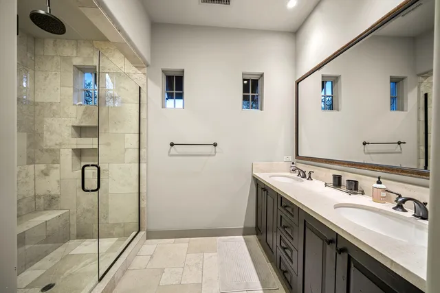 a bathroom with a shower sink and mirror