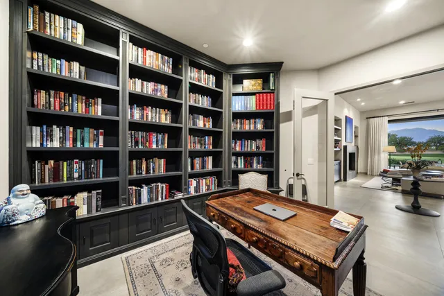a room with a table chairs and flat screen tv