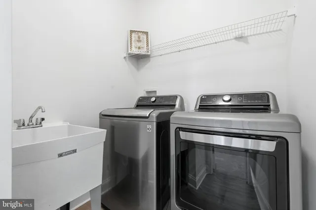 a spacious bedroom with a bed and a chandelier