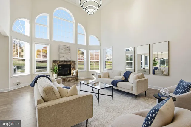 a living room with furniture and floor to ceiling windows
