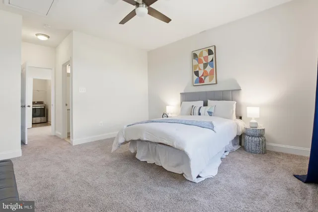 a living room with furniture and a wall painting