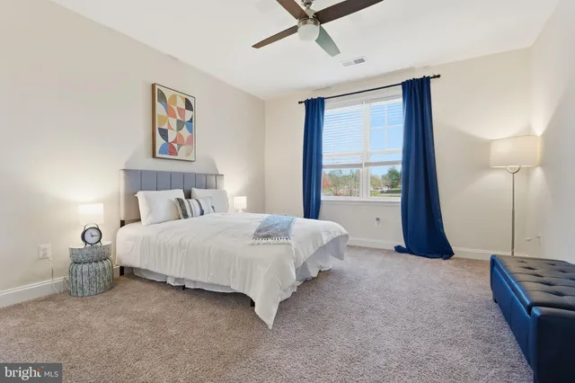 a living room with furniture and large windows