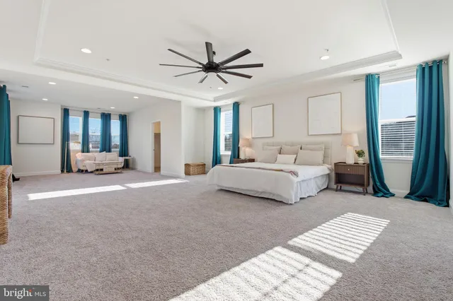 a living room with furniture and large windows