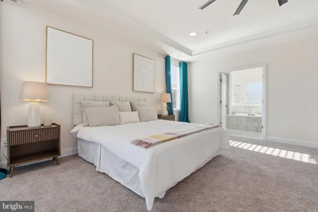 a view of empty room with wooden floor and kitchen view