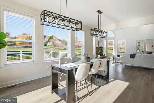 a kitchen with stainless steel appliances kitchen island granite countertop a sink a stove and a wooden floors