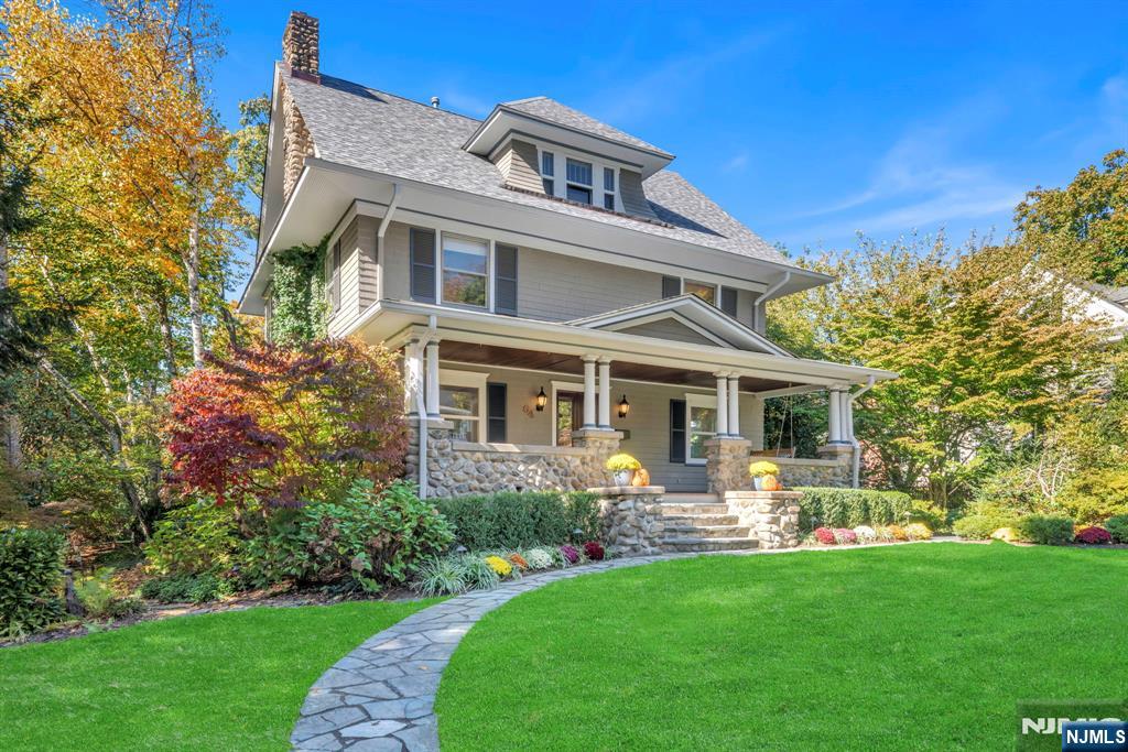 a front view of house with yard and green space