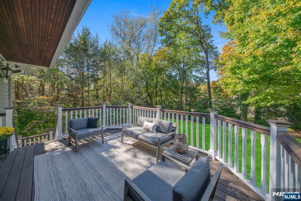 64 Park Slope Ridgewood, NJ 07450 - Photo 18 of 47 a view of a balcony with wooden floor table and chairs
