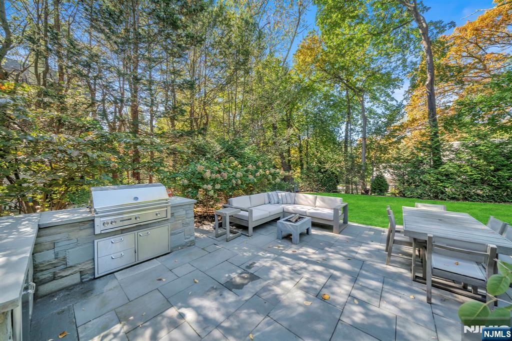 64 Park Slope Ridgewood, NJ 07450 - Photo 19 of 47 a backyard of a house with outdoor seating