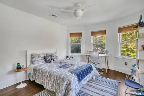 a bedroom with bed and a large window