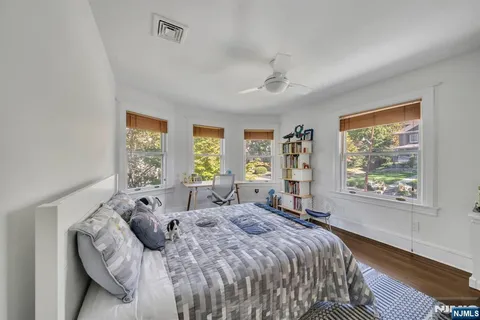 a bed sitting in a bedroom next to a window