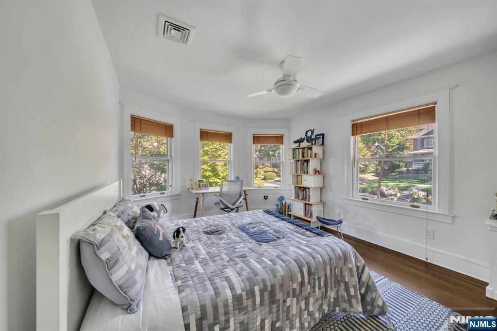 64 Park Slope Ridgewood, NJ 07450 - Photo 26 of 47 a bed sitting in a bedroom next to a window