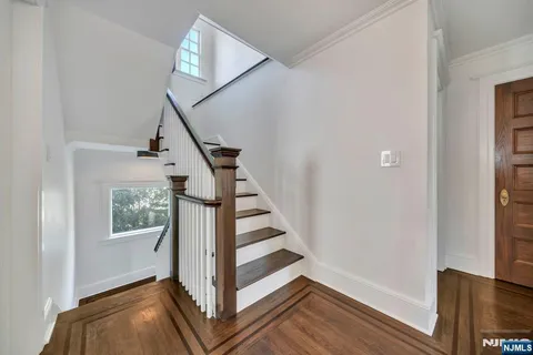 a view of entryway with wooden floor and stairs