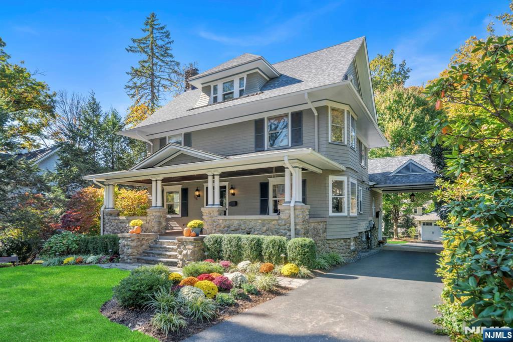 64 Park Slope Ridgewood, NJ 07450 - Photo 3 of 47 a front view of a house with a yard garden and outdoor seating
