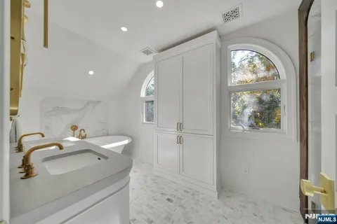 a bathroom with a sink and a large mirror