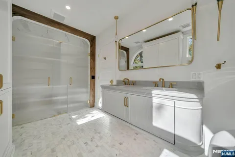 a spacious bathroom with a sink mirror vanity and a bathtub