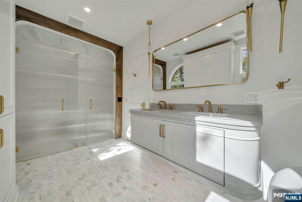 64 Park Slope Ridgewood, NJ 07450 - Photo 34 of 47 a spacious bathroom with a sink mirror vanity and a bathtub