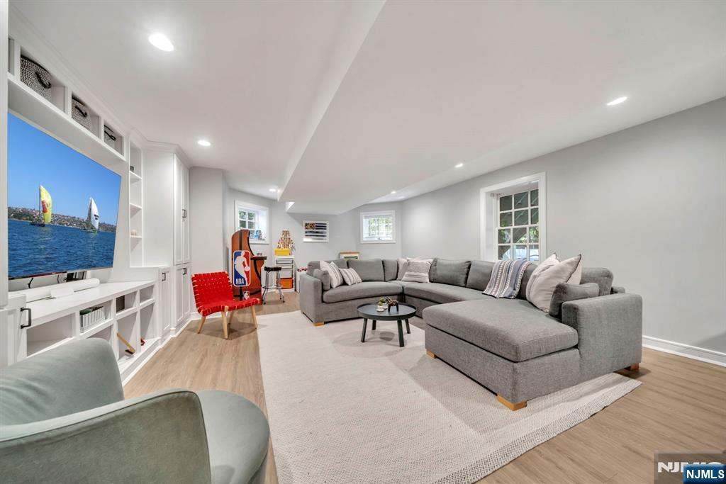 64 Park Slope Ridgewood, NJ 07450 - Photo 41 of 47 a living room with furniture kitchen view and a flat screen tv