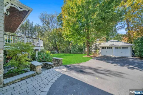 a view of a house with a yard and potted plants