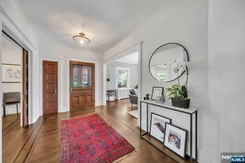 a living room with furniture and a mirror