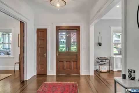 a hallway with furniture and wooden floor