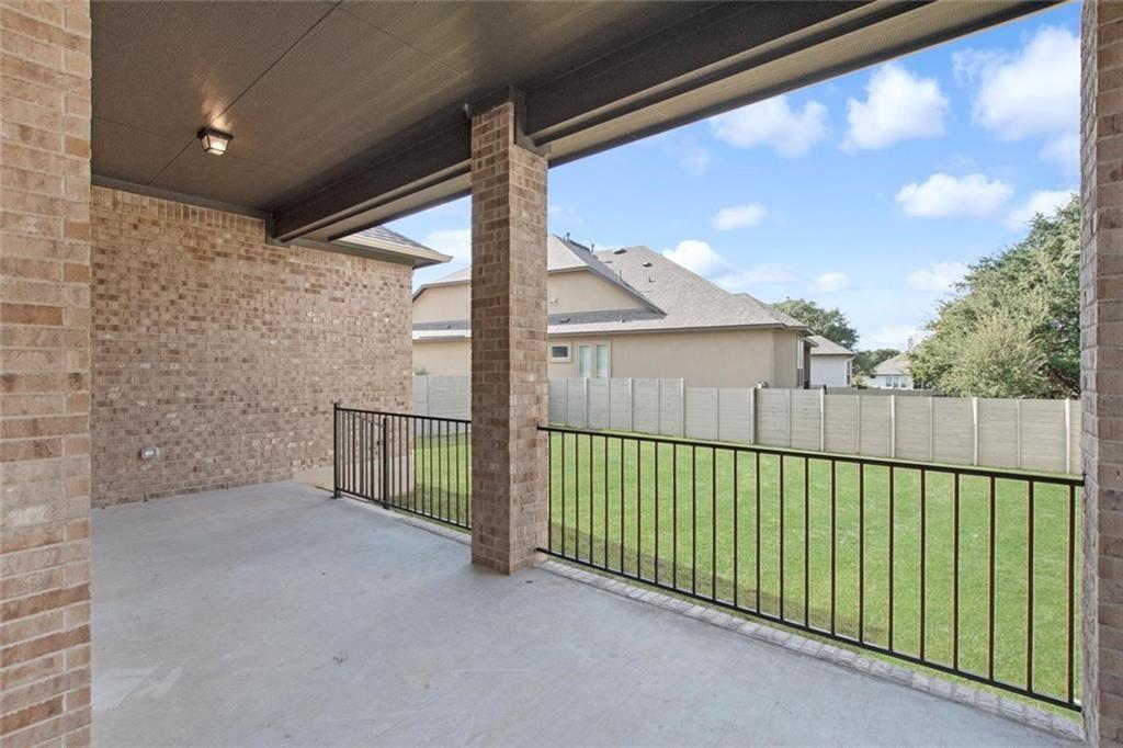 3833 Mercer Road Georgetown, TX 78628 - Photo 23 of 25 A spacious covered patio invites relaxation with a view of the private yard.