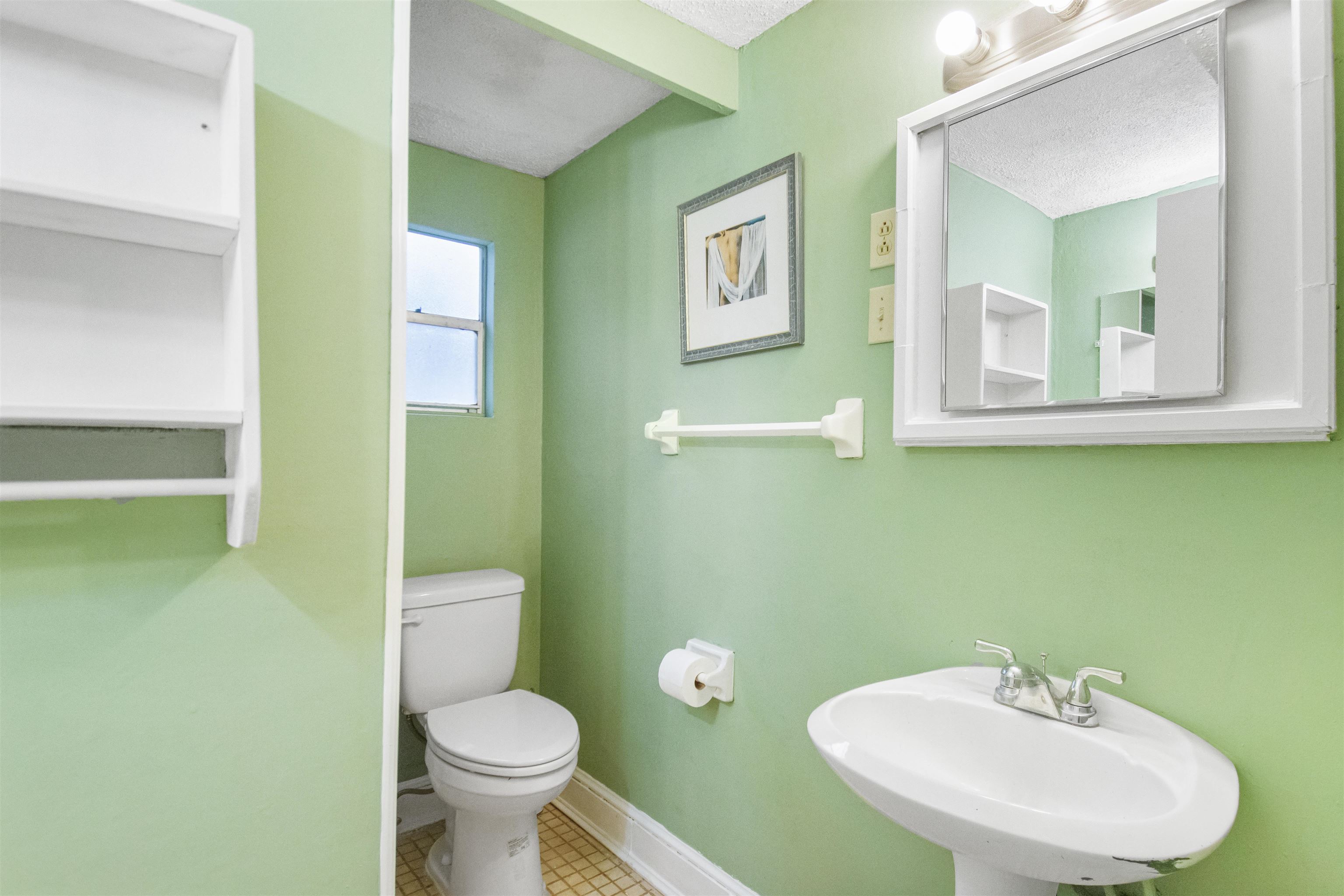 100 Spring Street St. Augustine, FL 32084 - Photo 13 of 21 a bathroom with a toilet sink and mirror