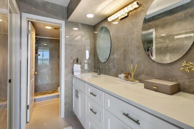 a bathroom with a granite countertop double vanity sinks and a mirror
