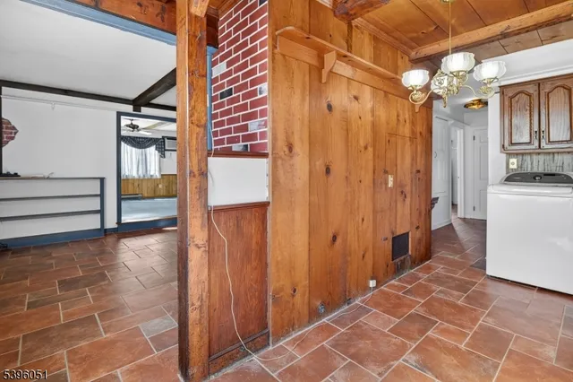 a view of a hallway with wooden cabinets