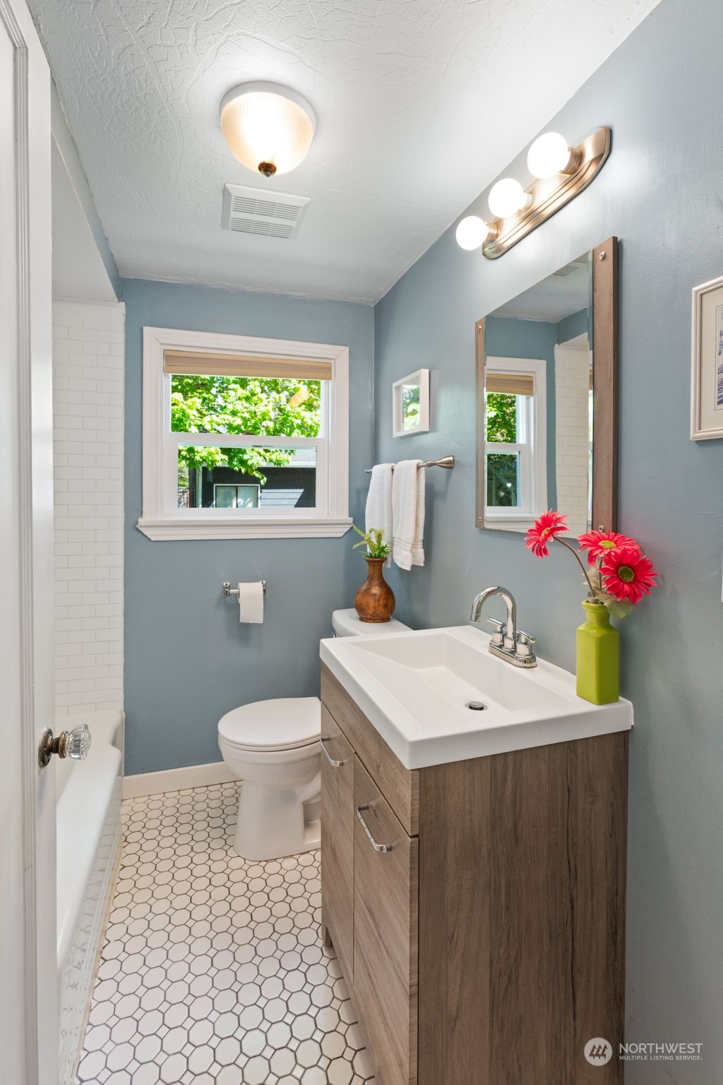 11616 6th Avenue Southwest Seattle, WA 98146 - Photo 17 of 37 a bathroom with a sink a toilet and a mirror