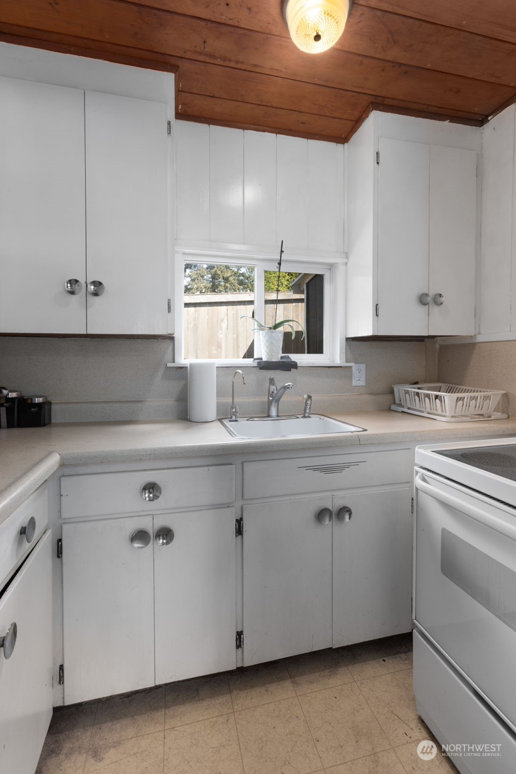 11616 6th Avenue Southwest Seattle, WA 98146 - Photo 27 of 37 a kitchen with granite countertop white cabinets and white appliances