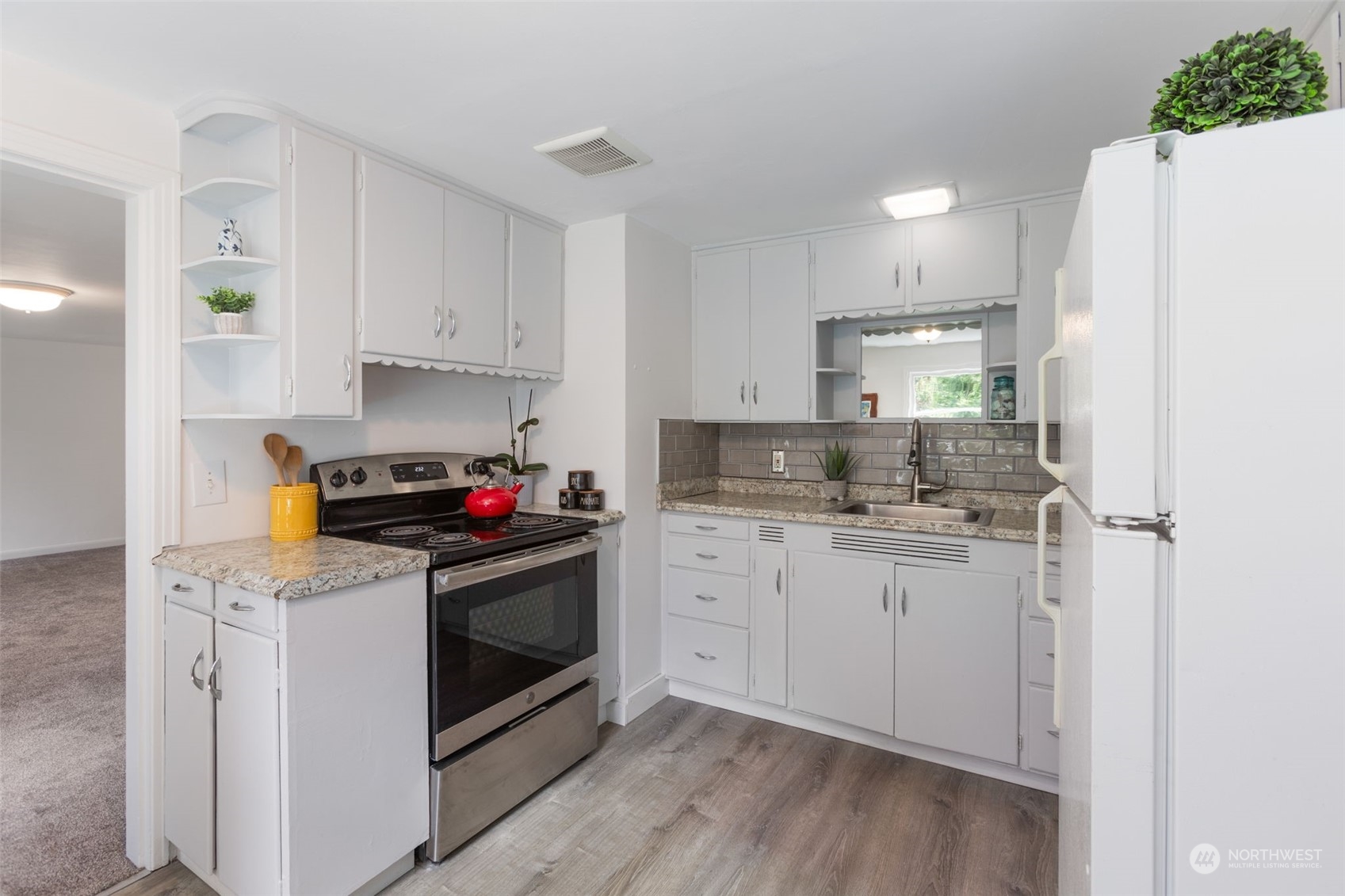 11616 6th Avenue Southwest Seattle, WA 98146 - Photo 3 of 37 a kitchen with stainless steel appliances granite countertop a stove a sink and white cabinets