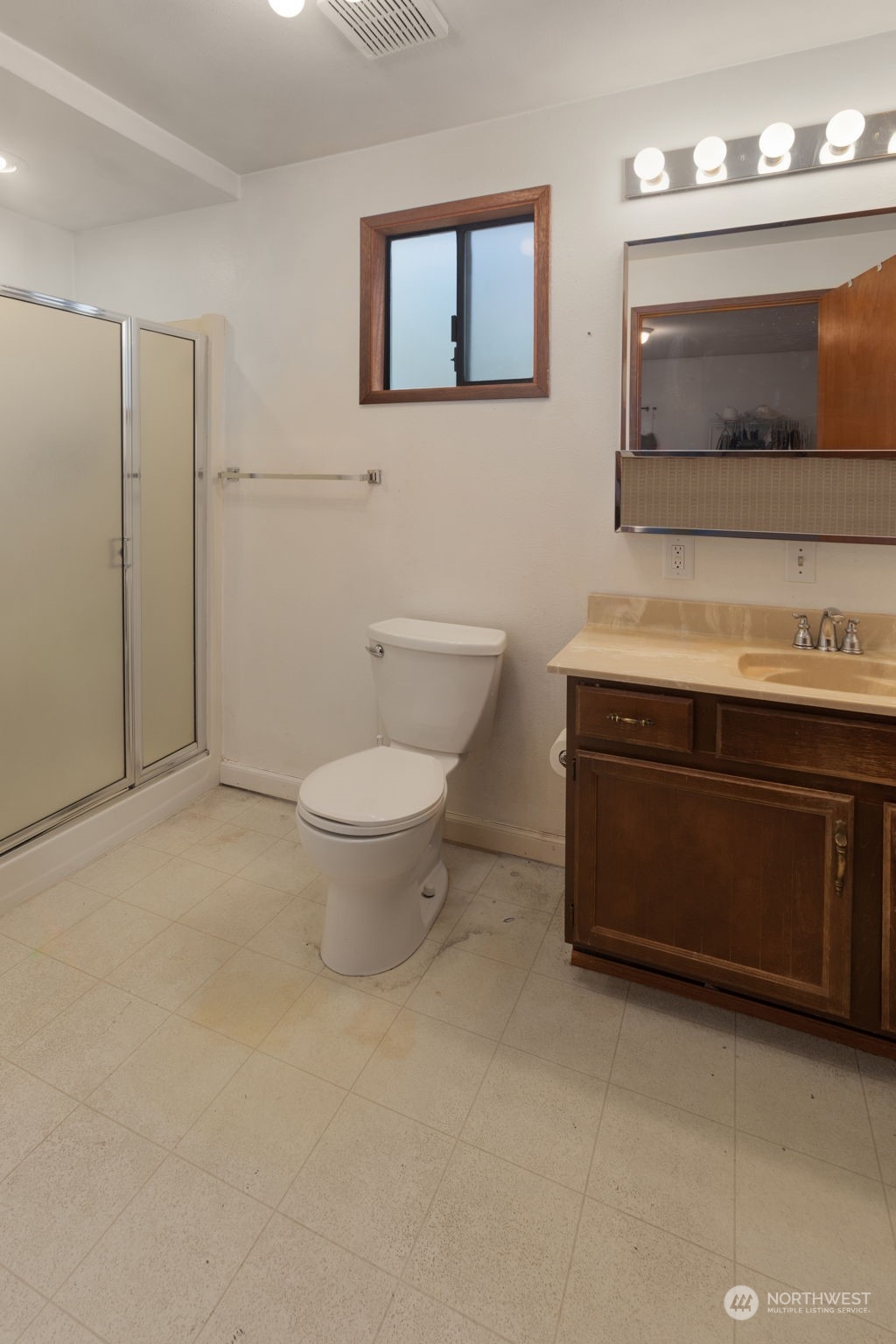 11616 6th Avenue Southwest Seattle, WA 98146 - Photo 31 of 37 a bathroom with a toilet sink and mirror