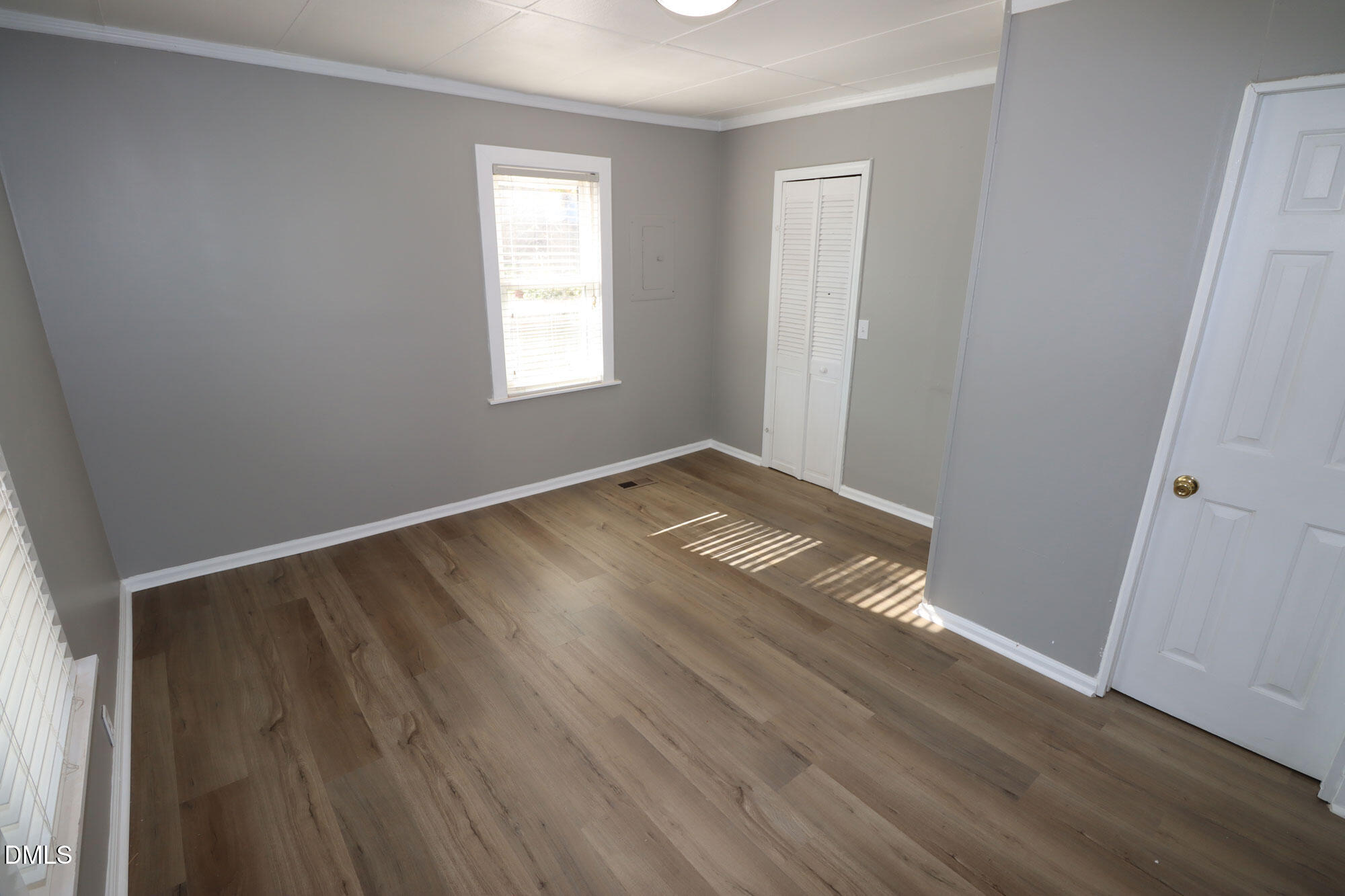 110 Emory Street Garner, NC 27529 - Photo 12 of 22 an empty room with wooden floor and windows